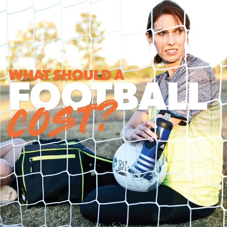 Female football player sitting in goal with ball and waterbottle at soccer training. The article talks about how much it costs for a good soccer ball / football ball