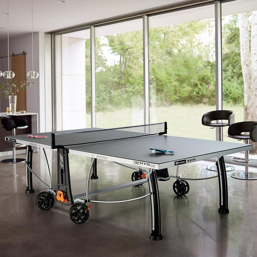 Table Tennis table at home indoors with ping pong bat and ball. Cornilleau table tennis table front of image