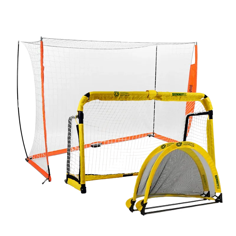 Kids playing soccer indoor with large soccer goal and soccer net. Girl is moving football around another young footballer to go take a shot on goal. The goalkeep is a young boy in red teamwear.  Professional portable soccer goal shown. Futsal size. 