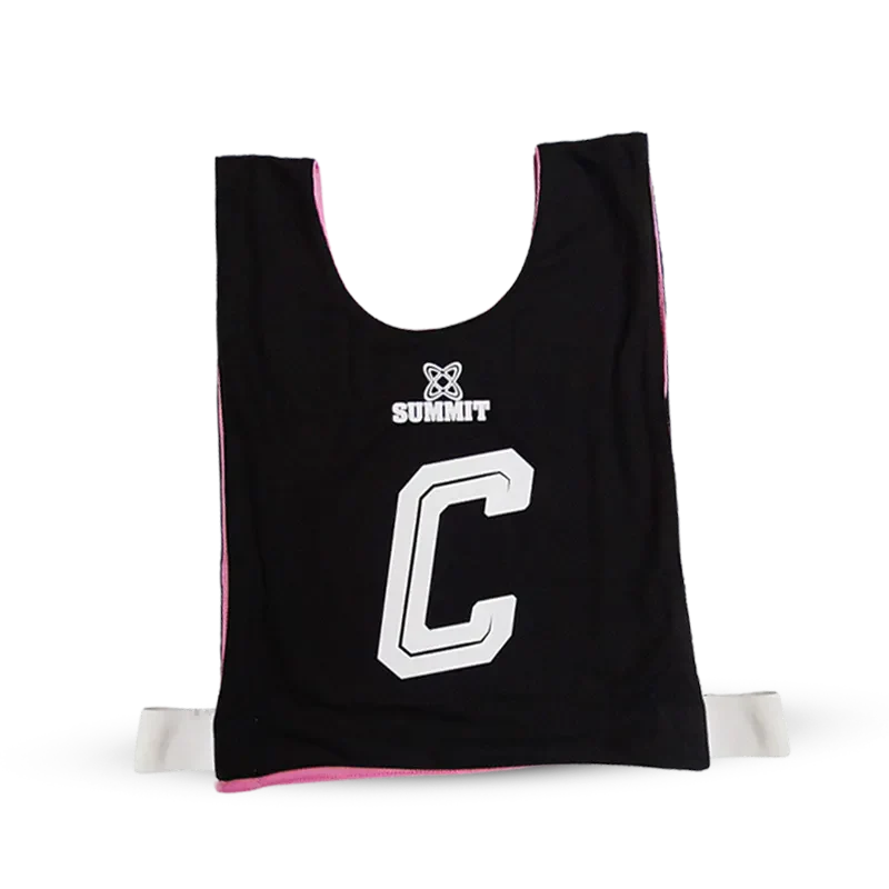 Black Netball Bibs Team Pack with GD, GA, GS, C, WD, WA GK positions. Pink on inside.