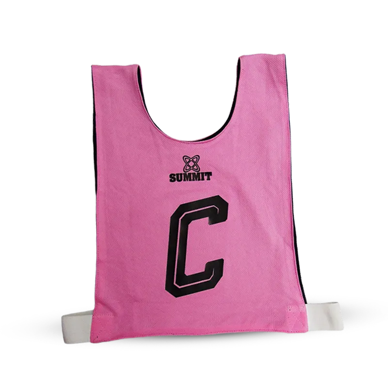 Maddy Turner in Pink Reversible Netball bib with elasticated sides and SUMMIT Netball in size 5