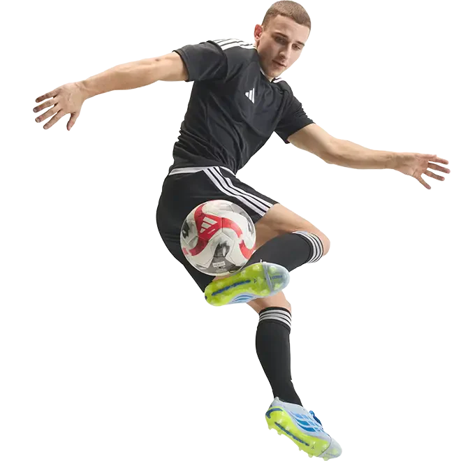 male soccer player kicking ball with side of boot while jumping