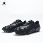 Pair of KELME Bolt Football Boots in black with red pattern on heel