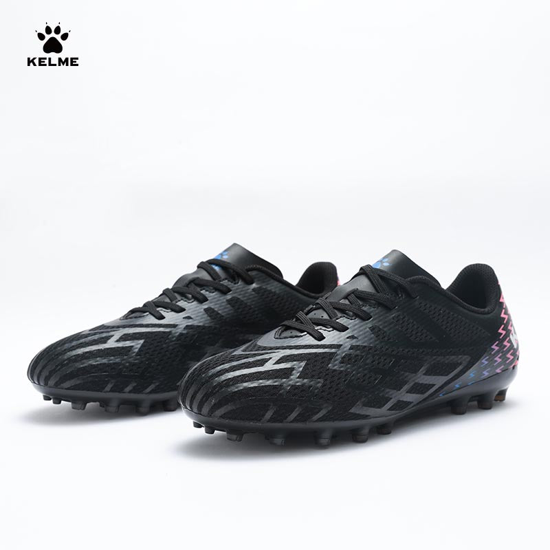 Pair of KELME Bolt Football Boots in black with red pattern on heel