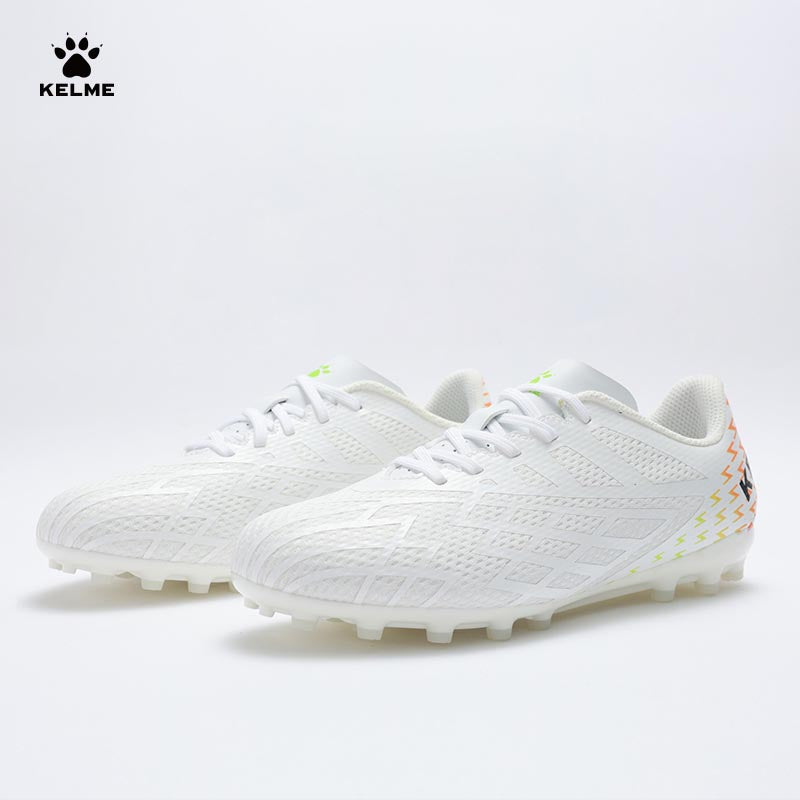 Pair of KELME Bolt Football Boots in white with red pattern on heel