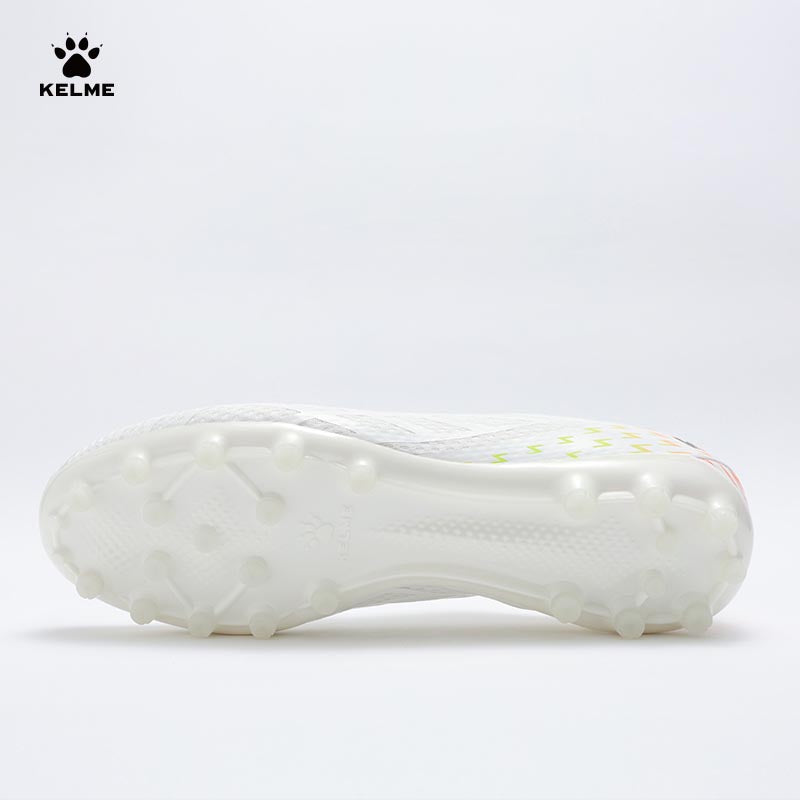 Single white KELME Bolt Football Boot, view from underneath showing the sole