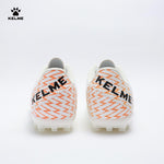 Back view of KELME Bolt Football Boots in white with orange pattern on heel