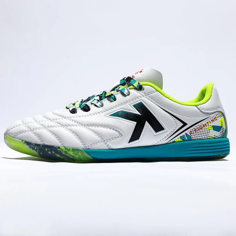 White sports shoe with green and blue accents on a light gray background