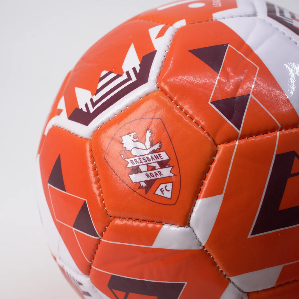 Brisbane Roar Soccer ball size 1 skill in orange and white close up of Brisbane Roar Logo