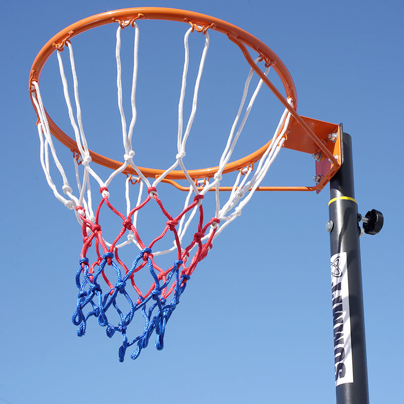 Netball ring and net against a clear blue sky. The hoop holds a white, red and blue net. Made by SUMMIT Sport