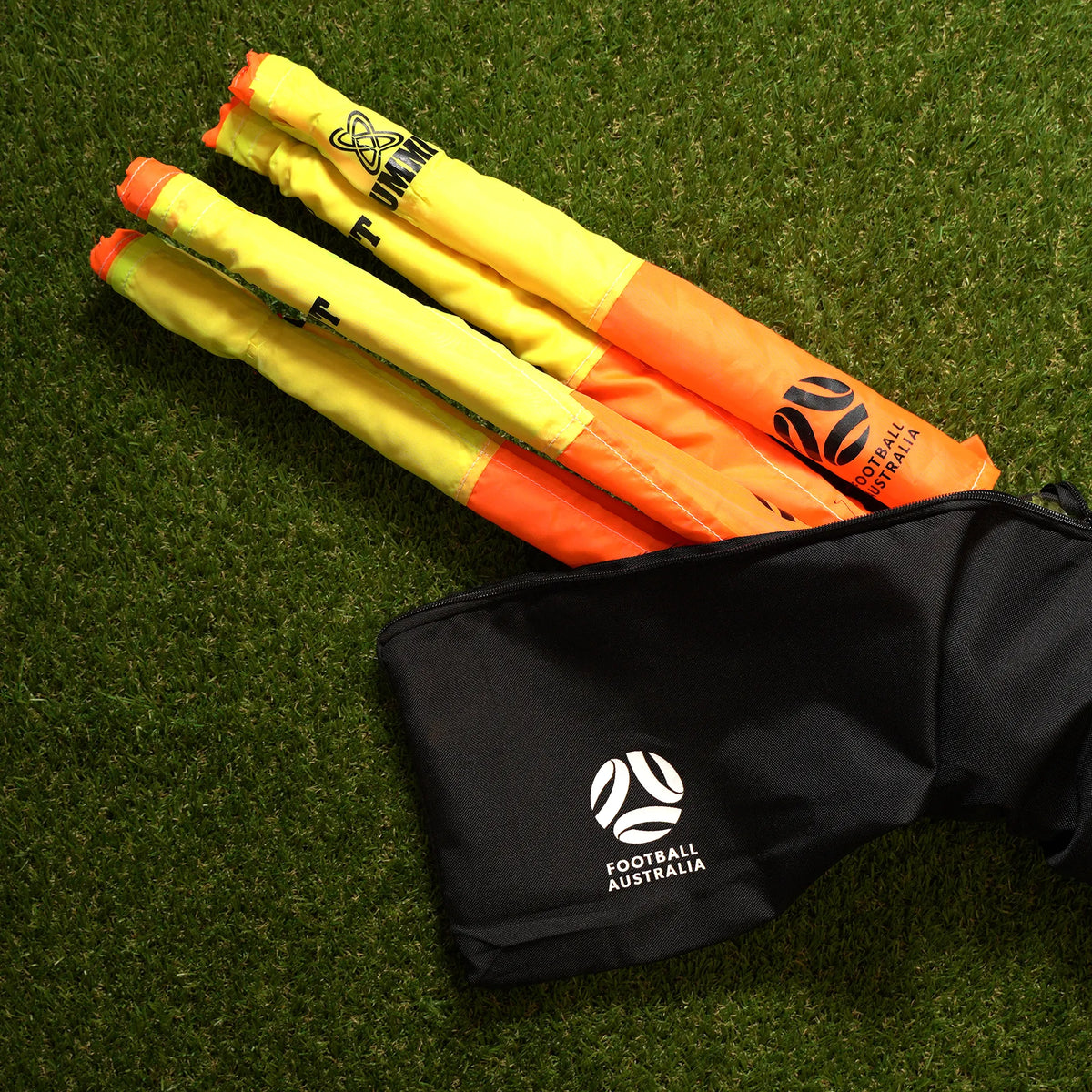 corner flags half out of zip up bag on grass