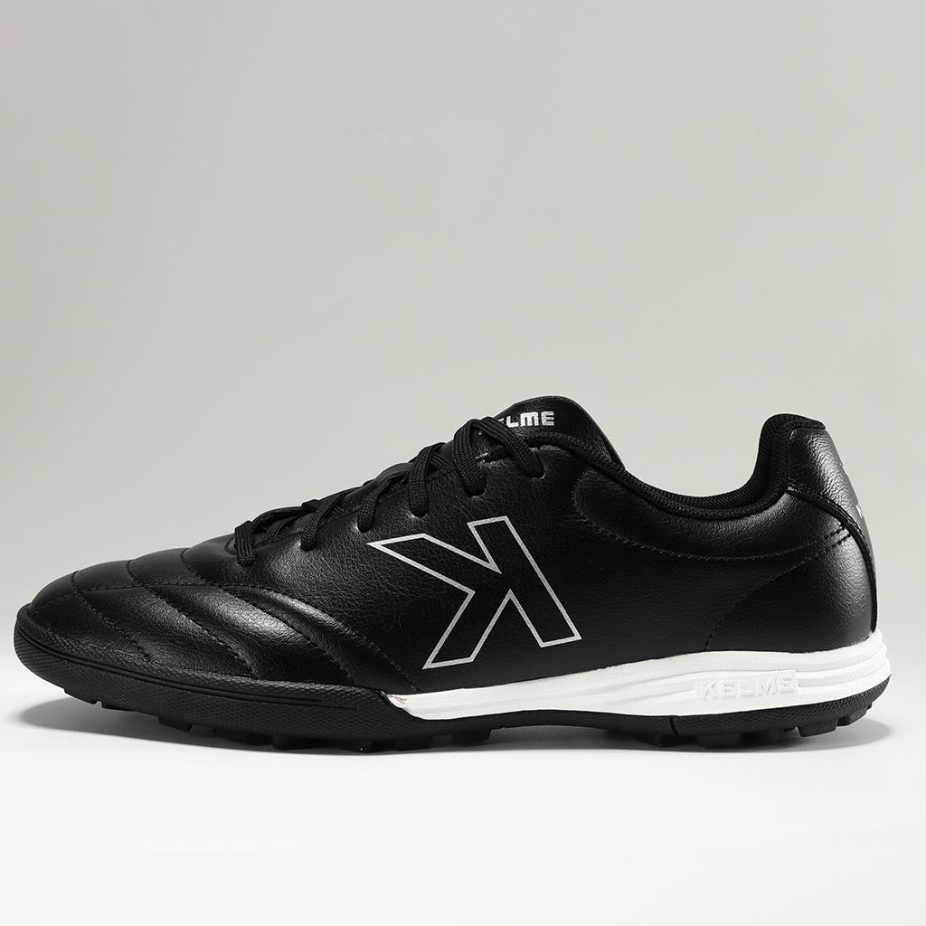 KELME Neo Sr Turf Boots for artificial surfaces - in black and white colour. Side view of single shoe.