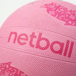 Close-up of a pink netball with 'netball' text on a white background