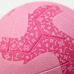 Close-up of a pink netball with branding on a white background