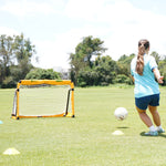Girl kicking soccer ball into aluminium folding soccer goal. Teenager training for soccer game using portable metal folding goal by SUMMIT Sport.
