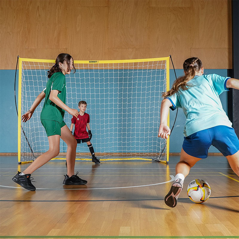Football Australia 2x3m flex futsal goal in use on indoor futsal court. Kids playing soccer using the SUMMIT Football Australia Flex Soccer Goal indoors. 