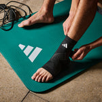 person wearing adidas Aeroready Ankle Support on a adidas yoga mat