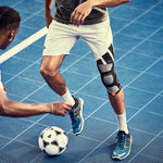 Person wearing an adidas knee support about to kick a soccer ball, on a court with a second person
