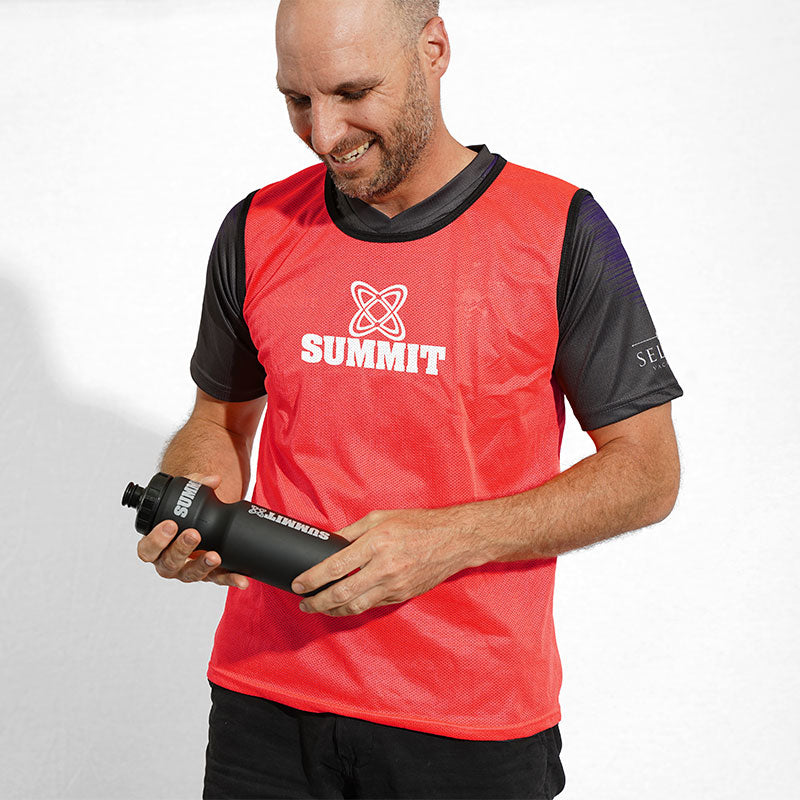 red mesh bib on man made for sports