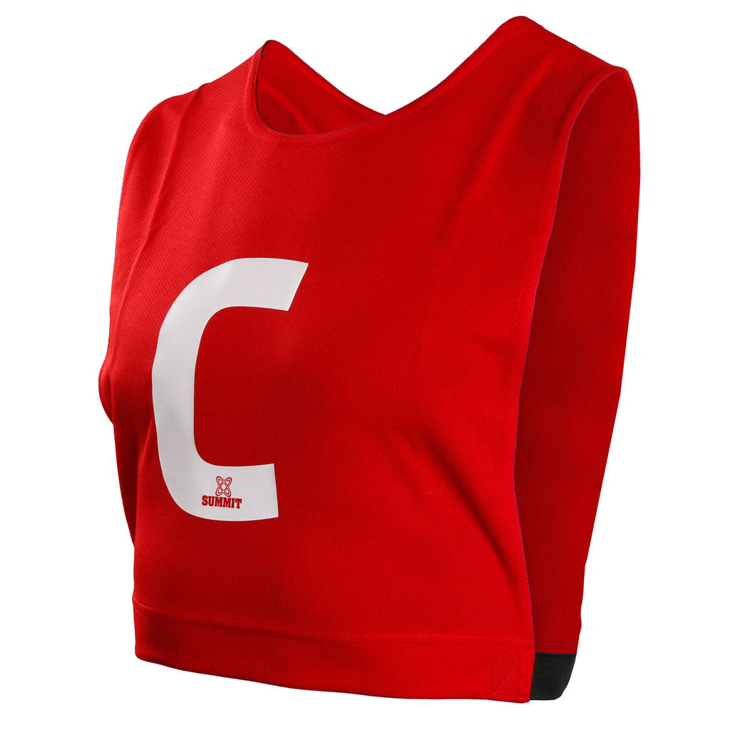 Red centre netball bib with elastic sides. Can be used for netball traiing. Netball bib fits kids and adult netballers.