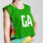 Goal Attack GA netball bib on young netball player. Green netball bib with elastic sides for easy fitment. Comes in a pack of 7 for netball teams