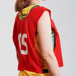 Goal Shooter GS netball bib on young netball player. Red netball bib with elastic sides for easy fitment. Comes in a pack of 7 for netball teams